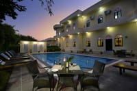 The swimming pool in the evening below the rooms