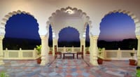 The upper terrace at dusk, looking out through the arches to the hills