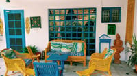 Verandah sitting area with blue-and-turquoise wicker furniture