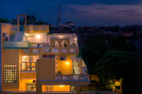 Coral Court exterior at dusk, lit house against evening sky