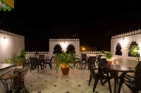 Rooftop terrace set for dinner at night