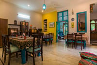 Dining room with dark-wood tables and turquoise doorways