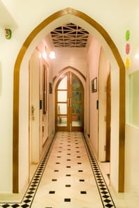 Arched corridor with black and white marble floor