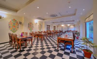 Jharokha restaurant with chequerboard floor and folk wall art