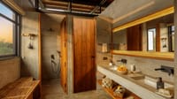 Luxury Room — bathroom with twin concrete basins, backlit mirror and walk-in shower at Bori Safari Lodge, Satpura