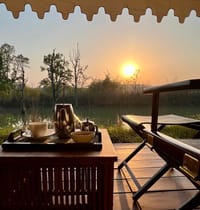 Tented Suite — coffee tray on the verandah at sunset overlooking the lake at Bagh Villas, Kanha