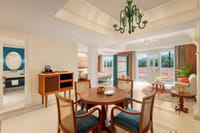 SeleQtions Suite living and dining area with round table, green glass chandelier and balcony views at Pilibhit House, Haridwar