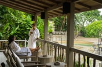 Presidential Suite veranda with guests in robes overlooking a plunge pool at Barahi Jungle Lodge, Chitwan