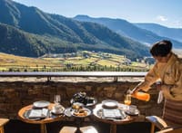 Breakfast being served at terrace tables above the valley at Gangtey Lodge, Gangtey