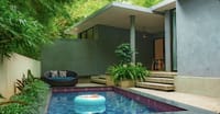 Shambhala villa private pool with rattan daybed beneath bamboo and a cantilevered concrete roof at Java Rain Resort, Chikmagalur