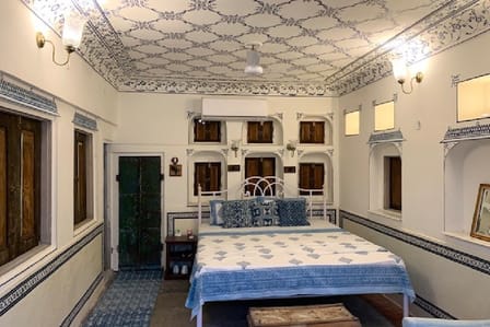 The Rooftop Double Room, under a patterned ceiling