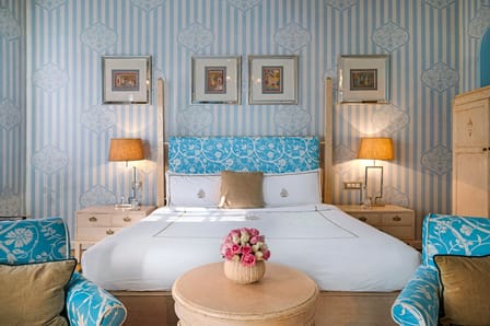 A Palace Room, papered in blue with framed miniatures