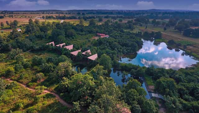 Pench Tree Lodge from the air, roofs and the lake in forty acres of forest