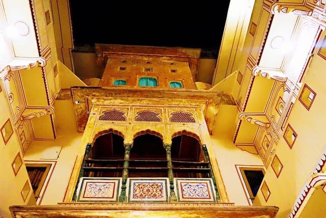 The carved facade of Haveli Patnawala, lit at night