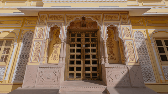 Carved jharokha window on the sunlit facade