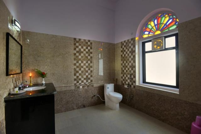 A bathroom with a stained-glass window