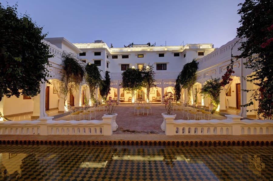 Central courtyard with cafe tables at dusk, Saraca Hotel Lucknow, Lucknow