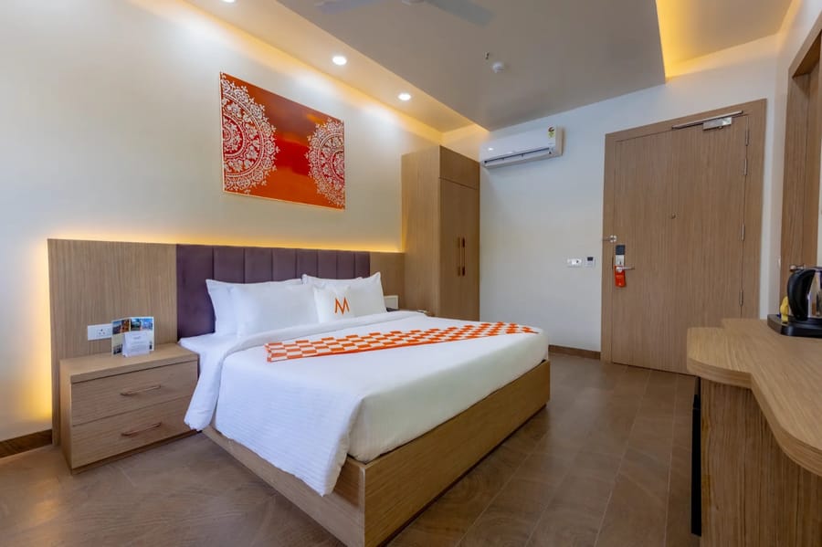 Premium Room with double bed, warm wood panelling and orange artwork, Mosaic Connect Ayodhya, Ayodhya