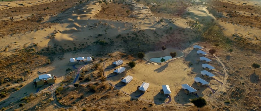Aerial view of the tented camp arranged around the desert pond, Dhora Desert Resort & Spa, Shekhala