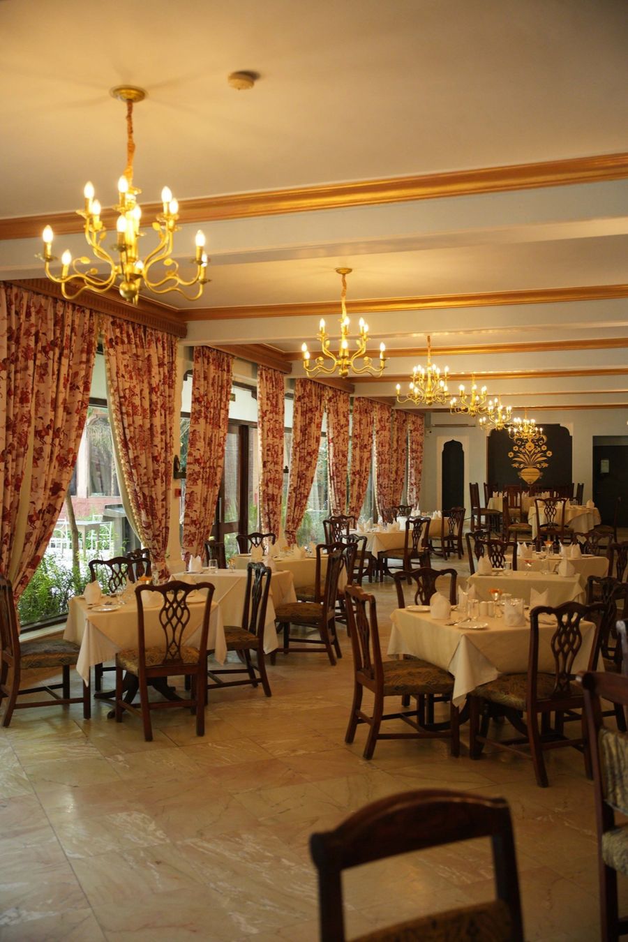 Panchranga restaurant interior with chandeliers and printed curtains, Ranbanka Palace, Jodhpur