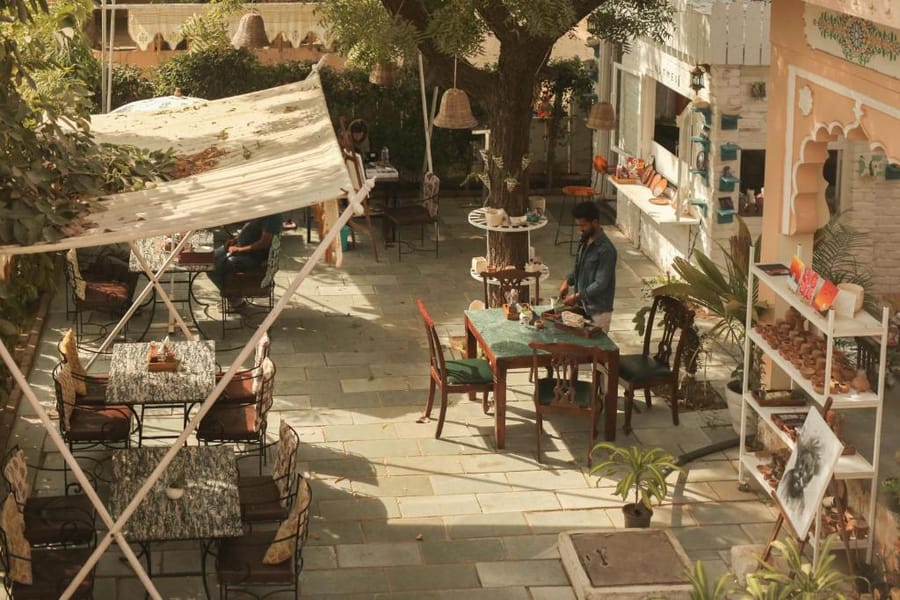The garden courtyard at Kothi Pushkar, laid for breakfast