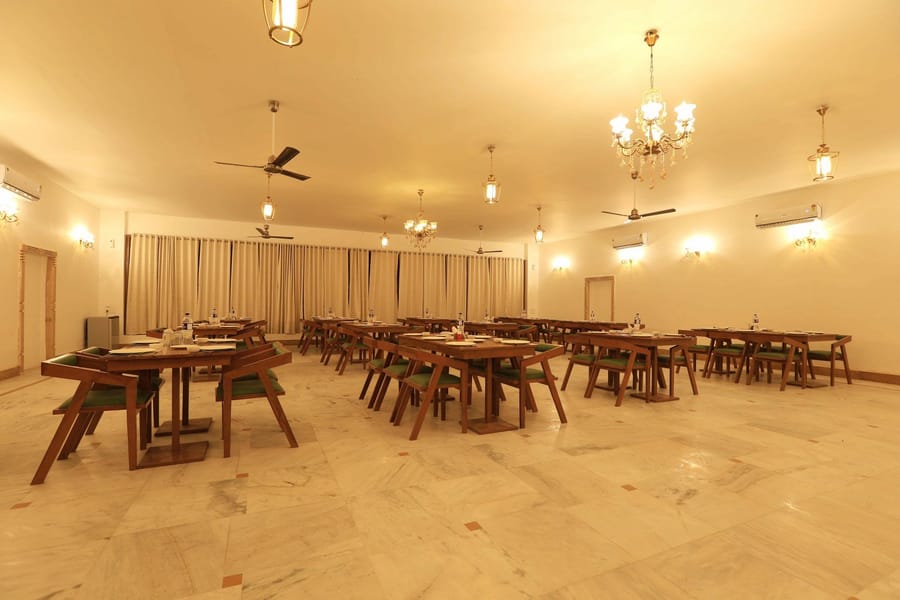 Restaurant hall with wooden tables and chandeliers