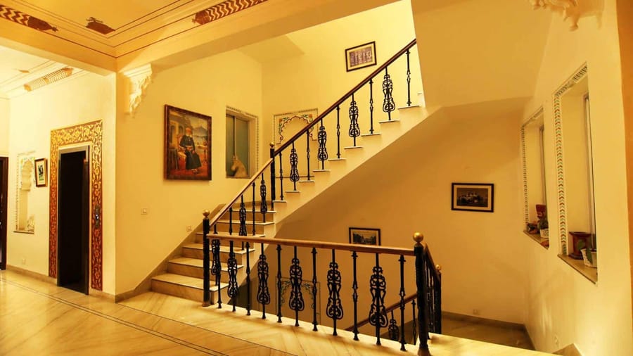 Whitewashed staircase with wrought-iron balustrade