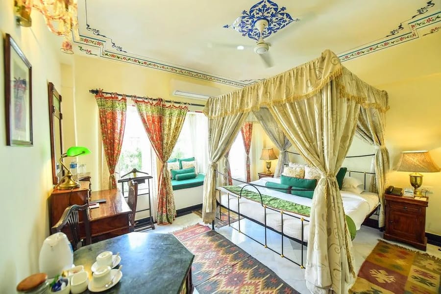 Udai Kothi room with painted ceiling and canopy bed