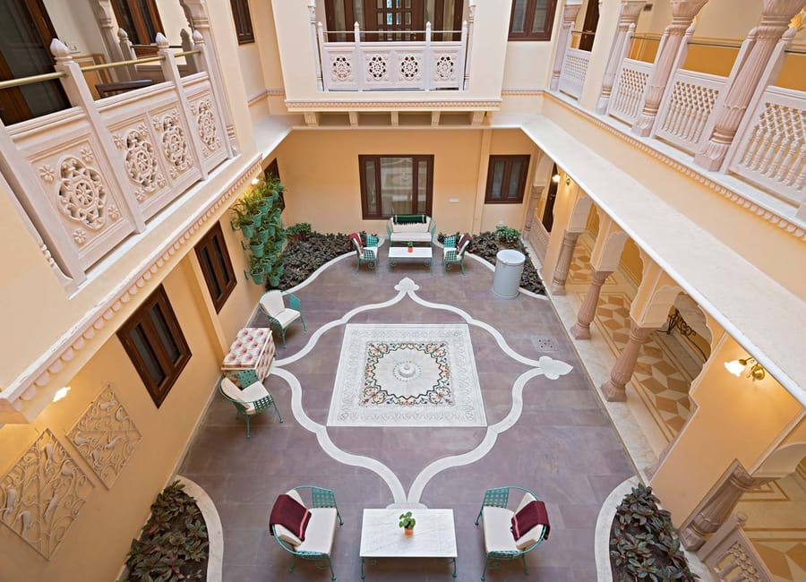 Overhead view of an inner courtyard with inlaid stone floor and seating