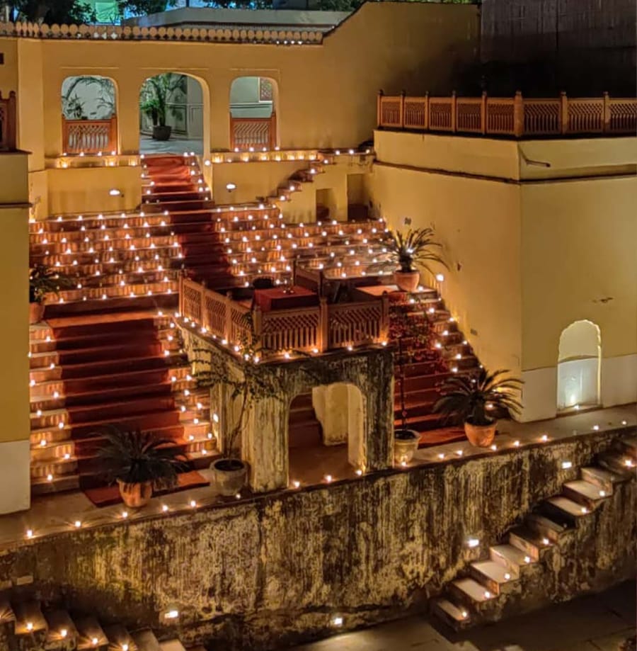 The private stepwell lit with oil lamps at night